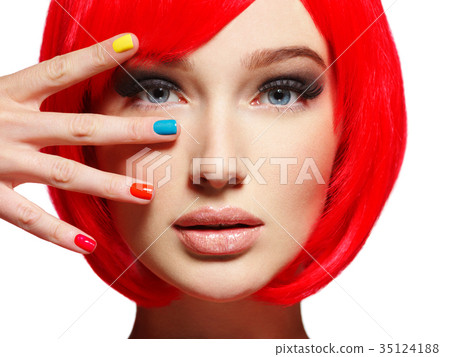 Closeup face of a beautiful  girl with  multicolor nails. 35124188