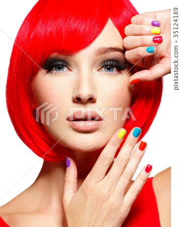 Closeup face of a beautiful  girl with  multicolor nails. 35124189