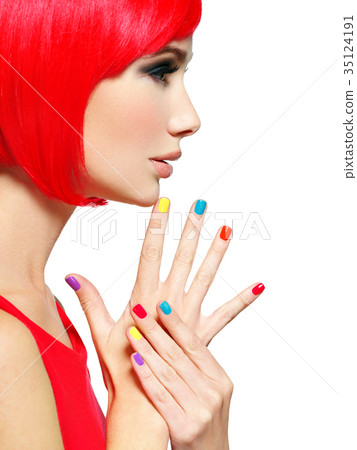 Closeup face of a beautiful  girl with  multicolor nails. 35124191