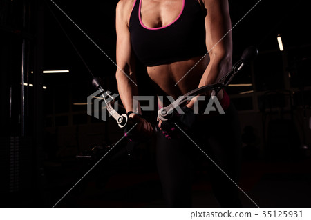 Strong Sporty girl in gym doing exercises Strong Sporty girl in gym doing exercises 35125931