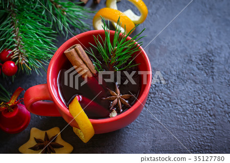 Mulled wine in red mugs and Christmas background Mulled wine in red mugs and Christmas background 35127780
