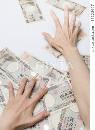 Hand trying to grab a lot of money Hand trying to grab a lot of money 35128697