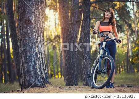 cyclist cycling mountain bike on Pine forest trail cyclist cycling mountain bike on Pine forest trail 35130925