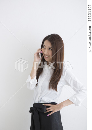 A woman talking on a smartphone 35131105