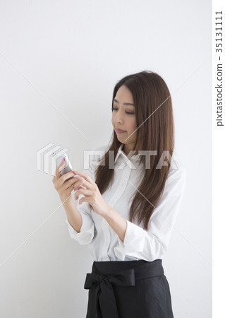 A woman talking on a smartphone 35131111