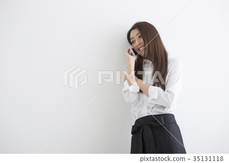 A woman talking on a smartphone 35131118