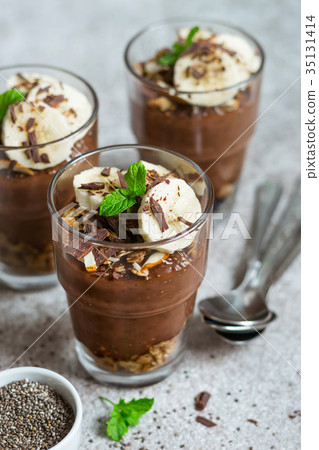 Chocolate pudding with chia and banana in glasses Chocolate pudding with chia and banana in glasses 35131414