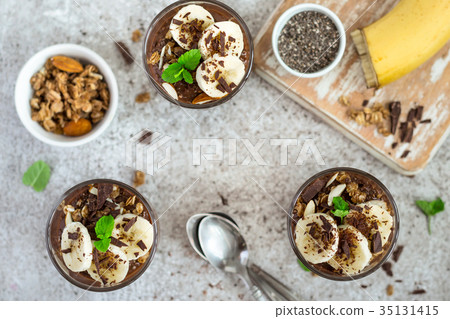 Chocolate pudding with chia and banana in glasses 35131415