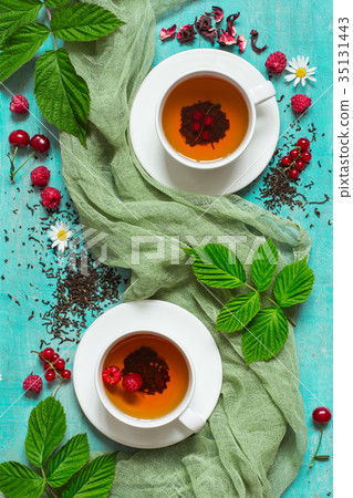 Summer tea with berries in white cups 35131443