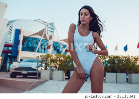 Sexy Woman standing in a white swimsuit. Mock-up. Sexy Woman standing in a white swimsuit. Mock-up. 35133341