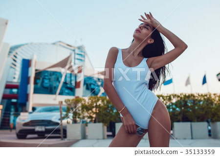 Sexy Woman standing in a white swimsuit. Mock-up. Sexy Woman standing in a white swimsuit. Mock-up. 35133359