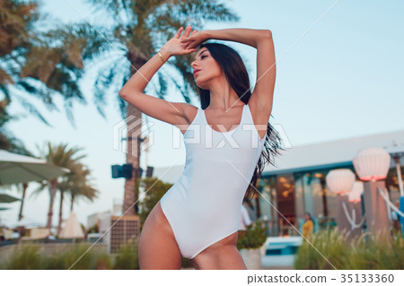 Sexy Woman in a white swimsuit on a background of Sexy Woman in a white swimsuit on a background of 35133360