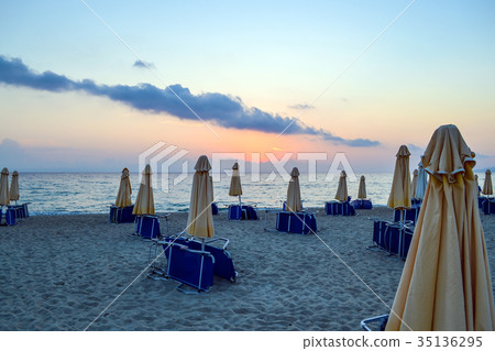 Empty beach early morning. Closed parasols   35136295