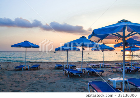 Empty beach early morning. Parasols and sunbeds Empty beach early morning. Parasols and sunbeds 35136300