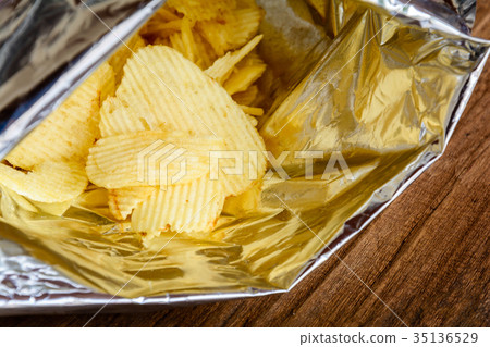 Snacks in a wooden bag on a table Snacks in a wooden bag on a table 35136529
