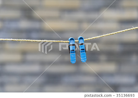 Two blue clothespins on a rope 35136693