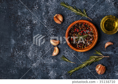 Dark food background with rosemary, garlic pepper. 35138710