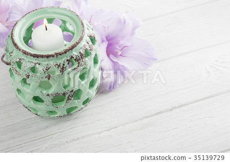 Mint green candlelight and purple flowers 35139729