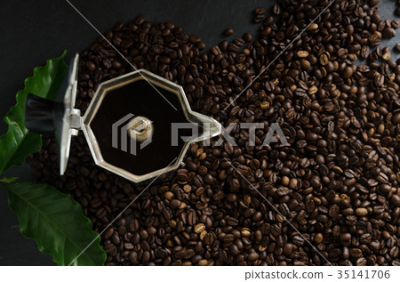 Italian coffee maker and coffee beans with leaves Italian coffee maker and coffee beans with leaves 35141706