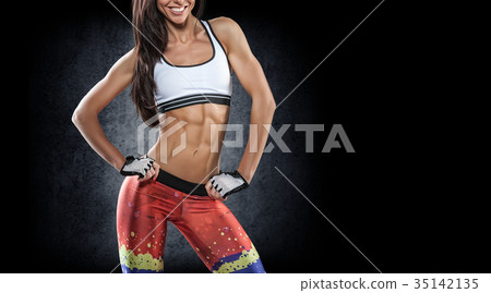 Sports. Woman at the gym doing stretching exercises and smiling Sports. Woman at the gym doing stretching exercises and smiling 35142135