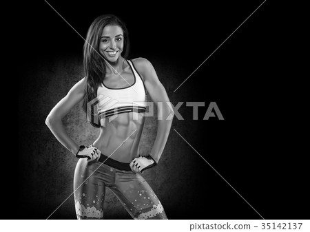 Sports. Woman at the gym doing stretching exercises and smiling Sports. Woman at the gym doing stretching exercises and smiling 35142137