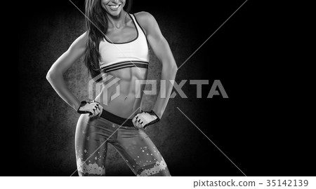 Sports. Woman at the gym doing stretching exercises and smiling 35142139