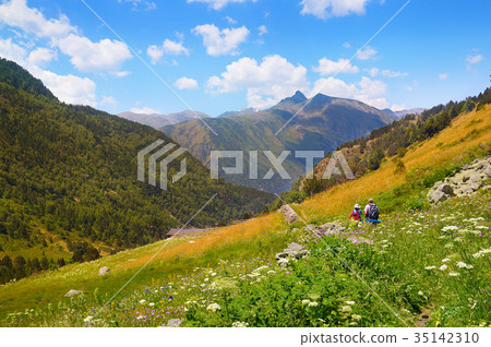 mountain scenery and tourists on hiking trail 35142310