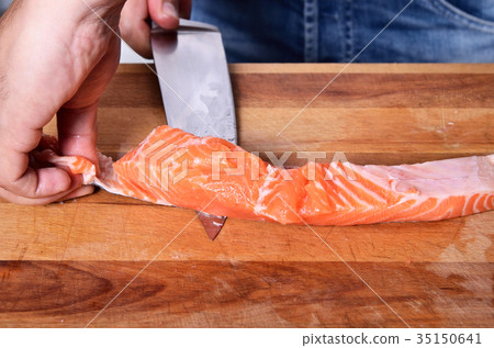 Cutting the salmon with a knife Cutting the salmon with a knife 35150641