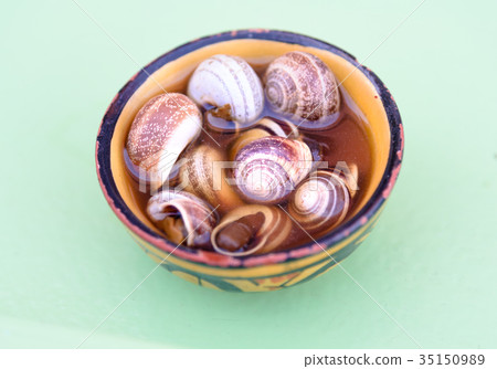 Boiled and cooked snails with shells in bowl 35150989