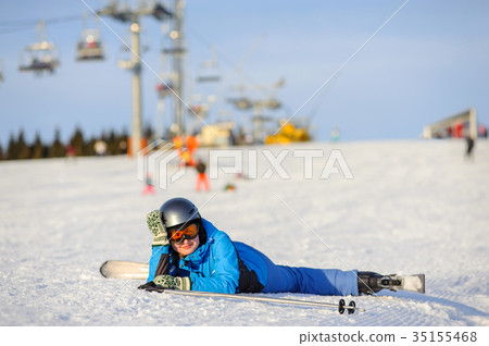 Young woman skier after the fall on mountain slope Young woman skier after the fall on mountain slope 35155468