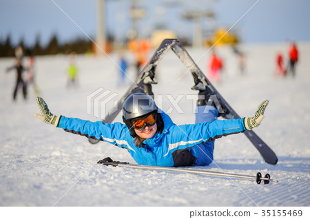 Young woman skier after the fall on mountain slope Young woman skier after the fall on mountain slope 35155469