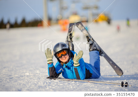 Young woman skier after the fall on mountain slope Young woman skier after the fall on mountain slope 35155470