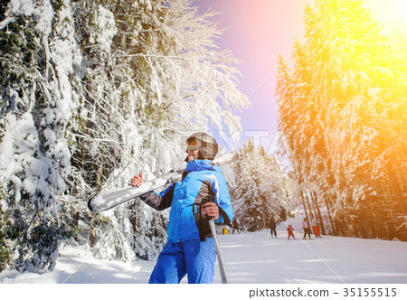 Female skier on a ski slope on a sunny day Female skier on a ski slope on a sunny day 35155515
