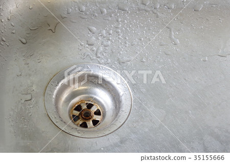 drop of water on silver stainless sink hole 35155666