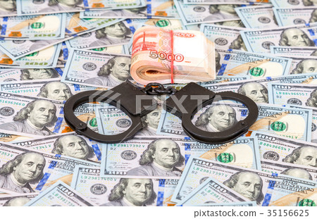 Steel police handcuffs lying on the background Steel police handcuffs lying on the background 35156625