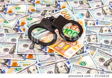 Steel handcuffs lying on the american dollars Steel handcuffs lying on the american dollars 35156626