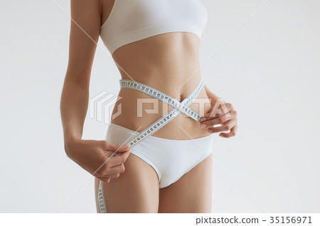 Young beautiful girl measures your body parts of 35156971