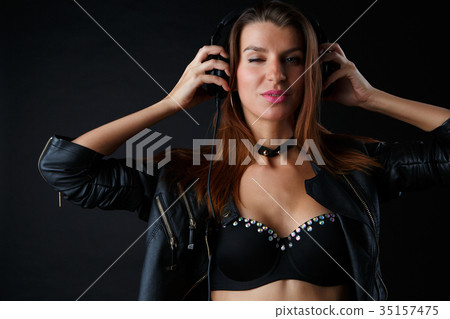 Photo of young brunette wearing headphones in Photo of young brunette wearing headphones in 35157475