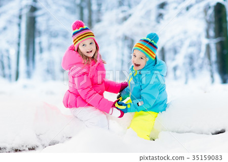 Kids playing in snow. Children play in snowfall. Kids playing in snow. Children play in snowfall. 35159083