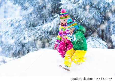Kids playing in snow. Children play in snowfall. Kids playing in snow. Children play in snowfall. 35159276