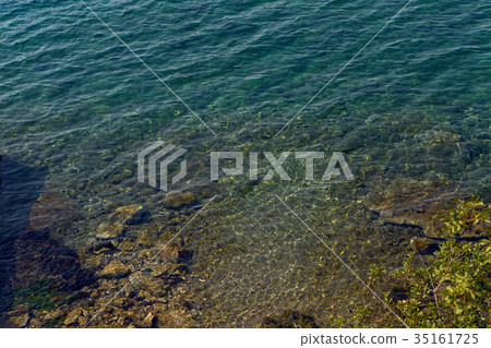 sea with a stone bottom and a blue clear water sea with a stone bottom and a blue clear water 35161725