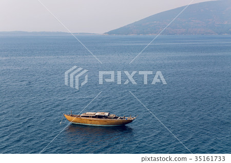 abandoned wooden boat anchored in the Bay abandoned wooden boat anchored in the Bay 35161733