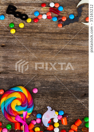 Colorful halloween candies on wood 35163212