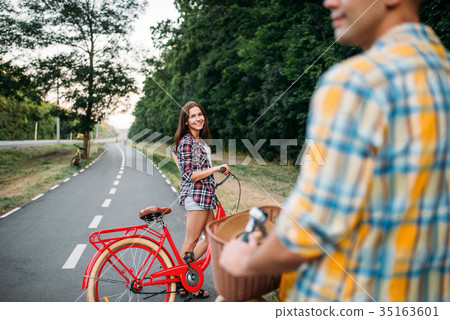 Male person and young woman riding on retro bikes Male person and young woman riding on retro bikes 35163601