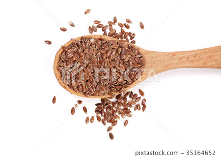 Flax seeds in a wooden spoon isolated on white 35164652