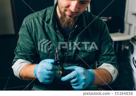 tattoo master artist prepares tools for tattooing tattoo master artist prepares tools for tattooing 35164838