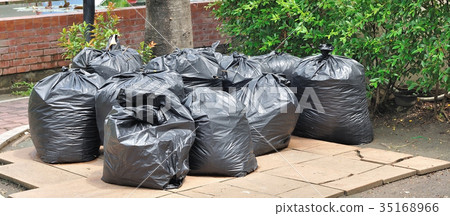 Pile of black garbage plastic bags on ground Pile of black garbage plastic bags on ground 35168966