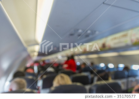 Blurred image interior of commercial airplane with passengers on 35170577