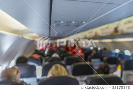 Blurred image interior of airplane with passengers on seats duri Blurred image interior of airplane with passengers on seats duri 35170578