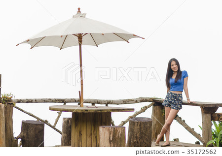 Asia young shy women sitting and smile on wood long chair Asia young shy women sitting and smile on wood long chair 35172562